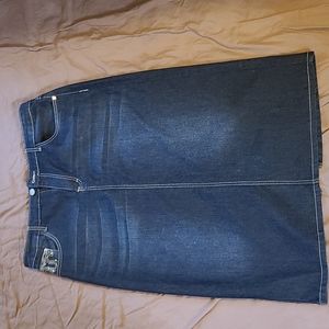 Long jean skirt with embellishments on pockets.